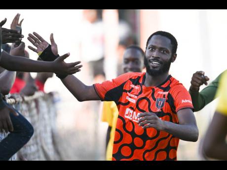 Credit: Ricardo Makyn Tivoli’s Lennox Russell celebrates with fans after scoring what would be the winning goal in a 3-2 win over Waterhouse at the Edward Seaga Sports Complex, yesterday.