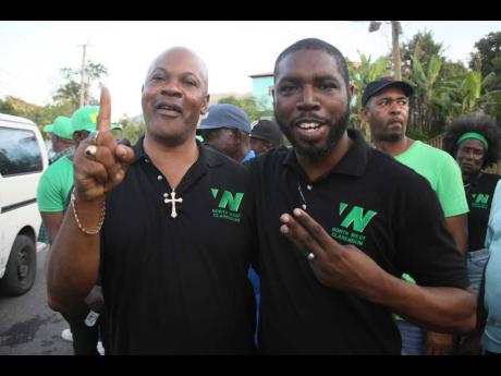 Credit: - Nathaniel Stewart Photo Former Senator Warren Newby celebrating with Clive Mundle, deputy mayor of May Pen and councillor for the Frankfield Division in Clarendon North Western. Newby won an internal Jamaica Labour Party vote to be the party's constituency representative on March