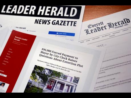 Credit: AP A selection of Everett Leader Herald News Gazette newspaper stories are displayed at the law firm representing Everett, Massachusetts Mayor Carlo DeMaria on December 20 last year in Boston.