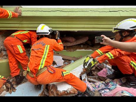 Credit: AP Myanmar rescuers search for survivors beneath a damaged building in Naypyitaw, Myanmar.