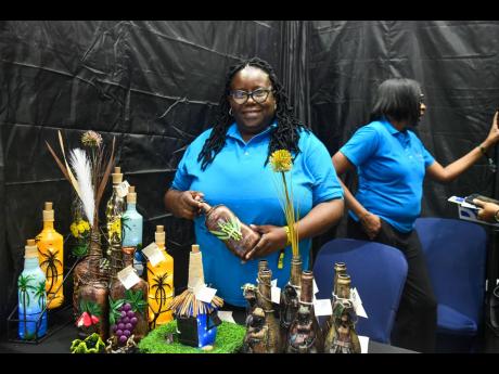 Credit: Matthew McKoy/Photographer Belinda Hall, the creative mind behind De Silva Hall Designs, shows off some of her preducts at EXPO Jamaica 2025 at the National Indoor Sports Centre on Thursday.