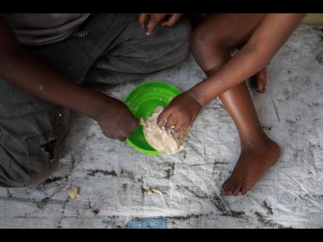 Credit: AP Moses Sawasawa Women and children eating on Tuesday, February 18, in a Goma eastern Congo school where they found shelter after their soldier husbands and fathers were sent to Rumangabo for mixing and integration into the M23 rebel forces.