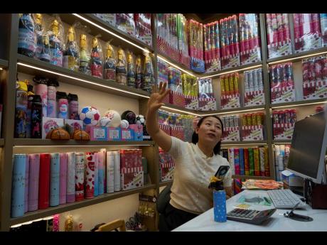 Credit: Ng Han Guan Jiang Jiayu, owner of Yiwu Jiayu Festive Supplies Co, an exporter of party poppers, speaks at the Yiwu International Trade Market in Yiwu, eastern China’s Zhejiang province on Thursday, April 10, 2025.