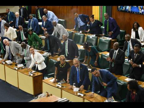 Government members applaud during the Throne Speech read by Deputy Governor General Steadman Fuller during the Ceremonial Opening of Parliament on February 13.
