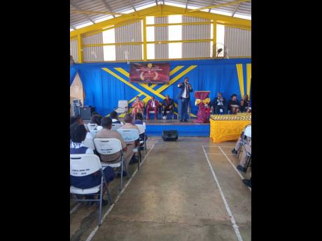Medals on the table, while Pastor Jermaine Johnson speaks to the audience.