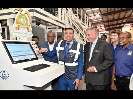 Credit: Rudolph Brown
Prime Minister Dr Andrew Holness flips the switch at the commissioning of Jamaica Packaging Industries Limited’s new factory at 693 Spanish Town Road, Kingston, on Tuesday, April 29, 2025. Looking on from left are JPI Country Manager Gary Cole; JPI Chai