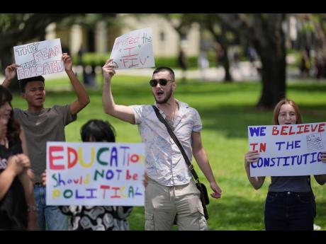 Credit: AP A group of Florida International University (FIU) students protest against cuts in federal funding and an agreement by campus police to partner with Immigration and Customs Enforcement, on the FIU campus.