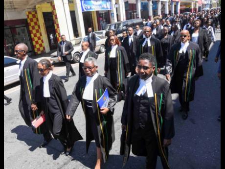 Members of the judiciary march along King Street in downtown Kingston in celebration of International Judiciary Day during the inaugural Judiciary Day held yesterday at Justice Square.