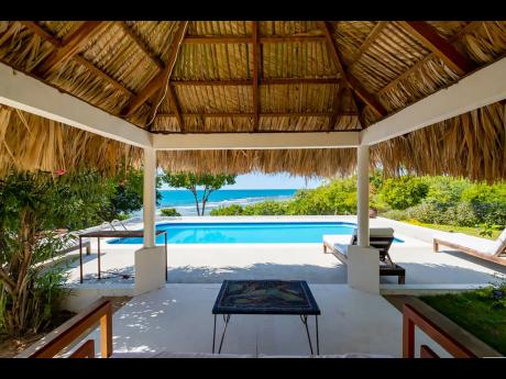 Credit: Contributed A sizable thatched-roofed gazebo is ideal for relaxation and entertainment.