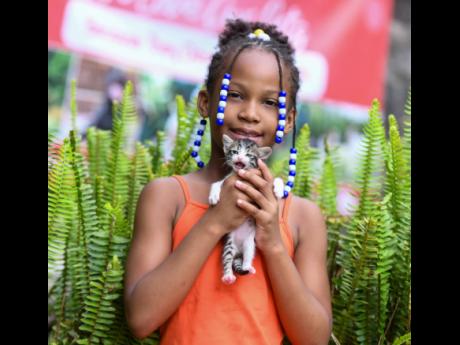 Credit: Antoine Lodge Eight-year-old Tesanna Bruff snuggles her adorable kitten, Sprinkles.