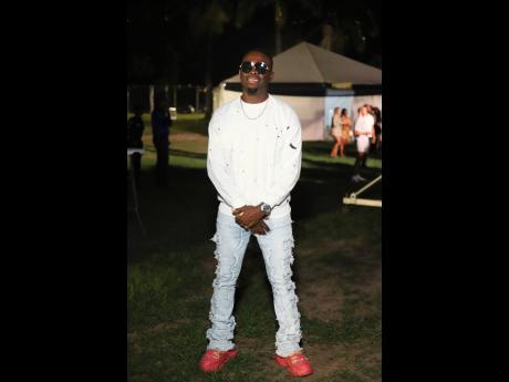 Credit: Contributed Omi steps out, pairing distressed denim with a white pullover, for a cool, comfort-focused look.