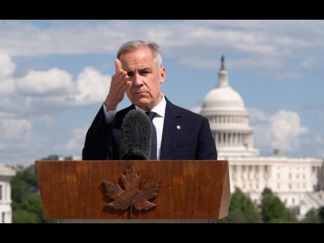 Credit: AP Canada’s Prime Minister Mark Carney gestures to a reporter as he takes questions during a news conference at the Canadian embassy in Washington, Tuesday, May 6.