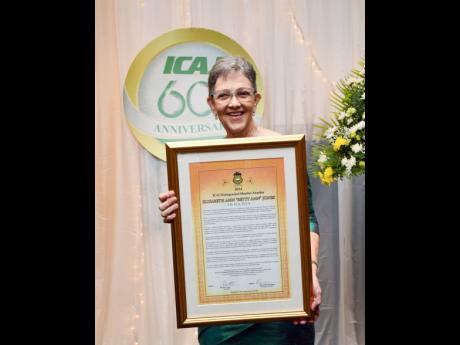 Credit: Contributed Elizabeth Ann Jones, chairman of The Jamaica National Group, proudly holds the citation recognising her as the recipient of the ICAJ’s 2024 Distinguished Member Award.