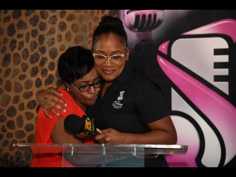 Credit: File Founder of the Sterling Gospel Music Awards, Basillia Barnaby-Cuff (right), embraces Sophia Laing, wife of veteran deejay Lieutenant Stitchie, after announcing a $150,000 donation to help cover the deejay’s medical expenses.