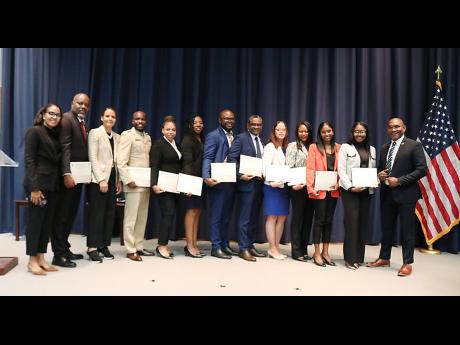 Credit:  Derrick Scott Jamaican law enforcement professionals proudly display their certificates after graduating from the prestigious Caribbean Security and Defence Course offered by the William J. Perry Center for Hemispheric Defence Studies in Washington, DC, on Friday, May 1