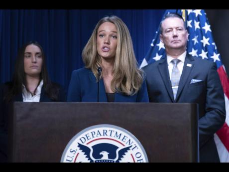 Credit: AP DHS Assistant Secretary for Public Affairs Tricia McLaughlin flanked by Deputy director of US Immigration and Customs Enforcement Madison Sheahan, left, and Acting director of US Immigration and Customs Enforcement Todd Lyons, speaks during a news conferen