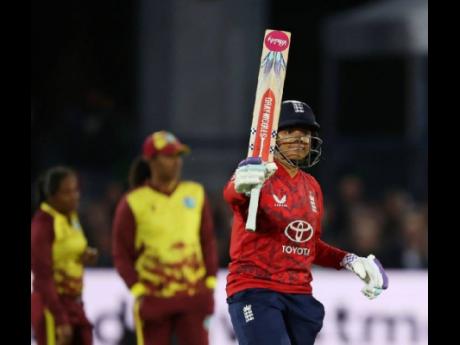 England Women’s Sophia Dunkley raises her bat after getting to 50, on her way to an unbeaten 81 against the West Indies Women during a T20I match in Canterbury yesterday.