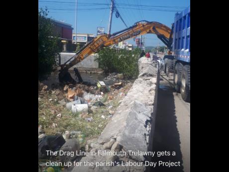 A heavy unit operator cleaning the gully in Falmouth, which was the Labour Day parish project.