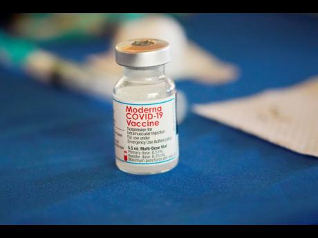 Credit: AP
A vial of Moderna COVID-19 vaccine rests on a table at an inoculation station.