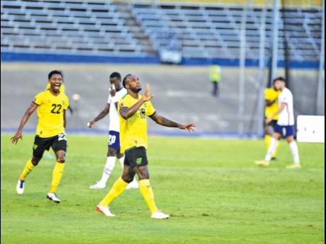 Credit: Paul-Andre Walker Gladstone Taylor/Multimedia EditorJamaica's Michail Antonio raises his hands to the sky after scoring a long-range effort to help his team equalise in their Concacaf World Cup qualifier at the National Stadium on Tuesday.
