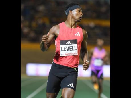 Credit: Ian Allen Bryan Levell looks over at his wind-aided 19.79-second clocking in the men's 200 metres at the Racers Grand Prix inside the National Stadium on Saturday.