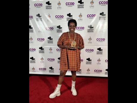 A delighted Kimberly ‘Kim Friez’ Morris poses with her GATFFEST award. 