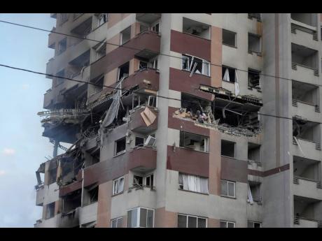 Damage is seen to an apartment building after Israeli attacks in Tehran yesterday.