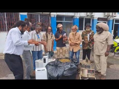 Rastas celebrate the return of their ganja outside the Westmoreland Parish Court on Tuesday.