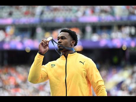 Roje Stona with his gold medal for his Olympic record-breaking win in the men's discus throw at Stade de France, Saint-Denis, Paris.