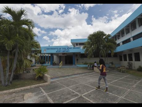 Credit: File In this August 21, 2018 Gleaner photo, a student walks in the vicinity of the UWI Main Library at the University of the West Indies, Mona campus.
