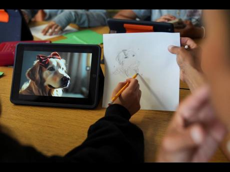 Credit: AP
A student, left, talks with art teacher Lindsay Johnson about how to ask ChatGPT for help during a summer class at Roosevelt Middle School in River Forest, Illinois.