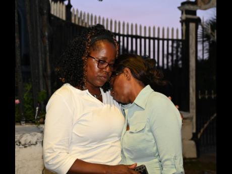 Andrea Fraser consoles her sister, Mercia Fraser, the mother of Mario Deane, as both react after the sentencing of three police personnel who were charged following Deane’s death in 2014.