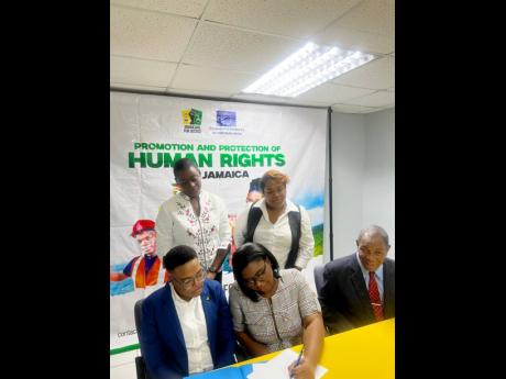 Representatives of the European Union and Jamaicans for Justice at a signing ceremony for awards to be granted by the partnership are seen here; back row: (from left) Vanna Lawrence, programme manager at the European Union and Venessa Parkinson, programme 