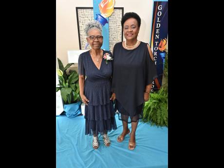 Awardee Dorothy Isaacs (left), who served over 50 years in education, poses with her daughter Sharon Isaacs at the JTA Golden Torch Award ceremony, held at The Jamaica Pegasus on Friday.