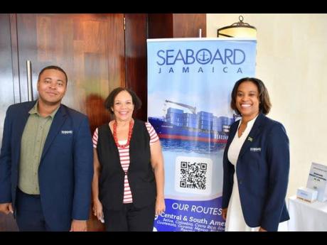 Corah Ann Robertson-Sylvester (centre), chief executive officer of Seaboard Freight and Shipping Jamaica and president of the SAJ, shares a moment with her team during the JAMPRO Exporter Information Session. Pictured with her are Adrian McIntosh, sales an