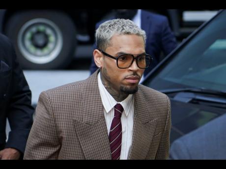 Credit: AP Grammy-winning singer Chris Brown makes his way into Southwark Crown
Court in London on Friday.