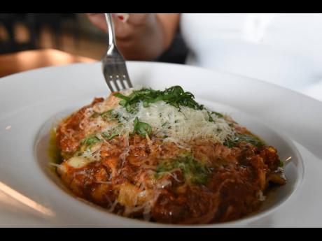 Dry-aged beef slow-cooked in house-made Scotch bonnet marinara sauce, topped with fresh Parmesan Reggiano and chiffonade basil.