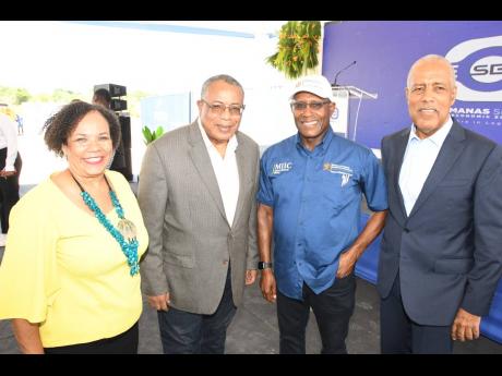 President of the Shipping Association of Jamaica, Corah Ann Robertson-Sylvester, shares a moment with (from second left) Opposition Spokesman on Industry, Investment and Global Logistics, Anthony Hylton; Minister of Industry, Investment and Commerce, Senat