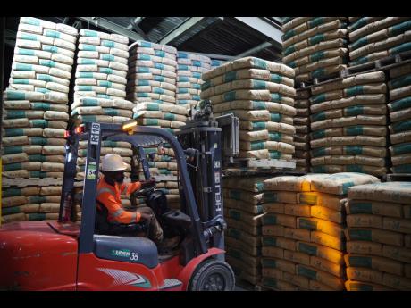 A forklift operator loading cement for transport.