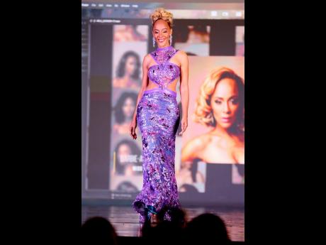 Barbie-Ann Mudahy makes her way down the stage in a purple cutout gown by Dermoth Williams Couture during the evening wear segment.
