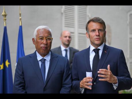 French President Emmanuel Macron, right, and Antonio Costa, President of the European Council, attend a statement following a video conference on Ukraine at the Fort de Bregancon in Bormes-les-Mimosas, southern France, Wednesday, August 13.