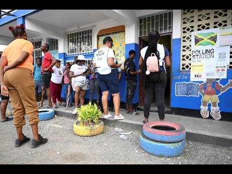 Voters waiting to cast ballots at the Morant Bay Primary School in St Thomas on Wednesday.