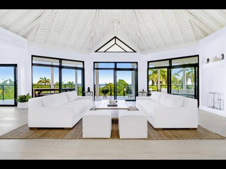 
The angular living room in all its splendour, enclosed within walls of sliding glass.