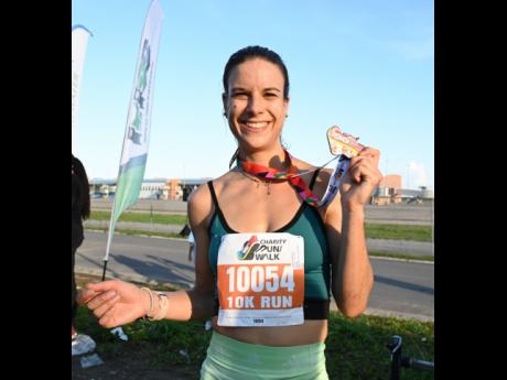 Cecile Heinrich celebrates after winning the female 10K Run at the MBJ Charity Run/Walk yesterday.