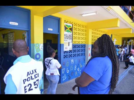 Credit: Antoine Lodge Election officers and voters are seen at the polling station at Jack’s River Primary School station in St Mary Western constituency.