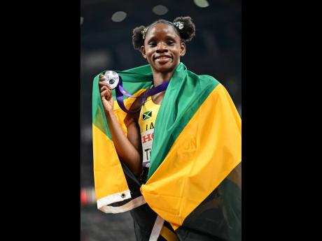 Credit: Gladstone Taylor Left: Tina Clayton celebrates with her silver medal after placing second in the women’s 100 metres final at the 2025 World Athletics Championships in Tokyo, Japan, yesterday.