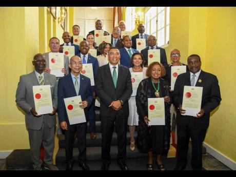 Credit: Antoine Lodge The prime minister and members of his cabinet pose for a photo: In front row (from left) are: Desmond McKenzie; Dr. Horace Chang; Prime Minister Dr Andrew Holness; Olivia Grange; Robert Montague. Second row: Daryl Vaz; Pearnel Charles Jr; Audrey Marks; Dan
