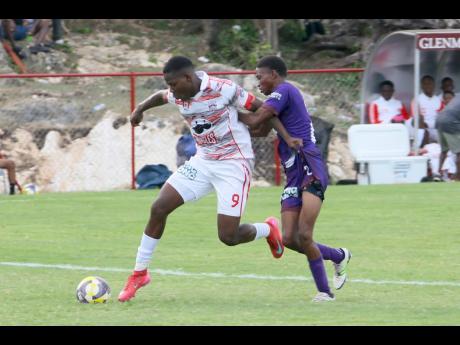Credit: Nathaniel Stewart Orane Watson (left) of Glenmuir High powers past Bustamante High’s Omario Brissettt in a daCosta Cup match on September 10.  
Hosts Glenmuir won 13-0 with Watson scoring eight times.