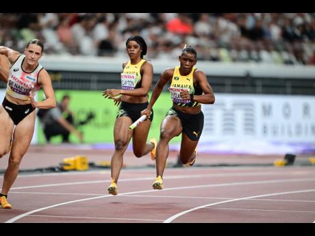 Jamaica’s Tia Clayton (centre) hands the baton over to Tina Clayton during a 4x100-metre heat at the World Athletics Championships inside the Japan National Stadium in Tokyo.