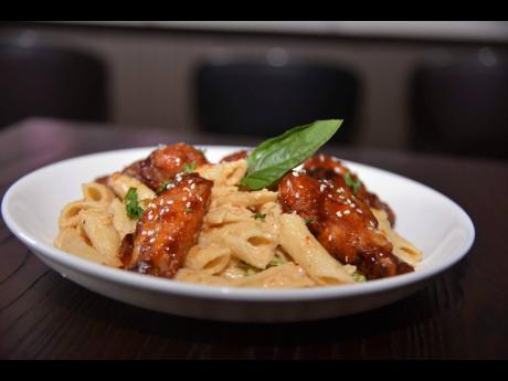 Azi’s Pasta Plates’ pasta and honey barbecue wings combo, topped with sesame seeds, brings together creamy comfort and crunchy sesame flavour in a crowd-favourite dish.